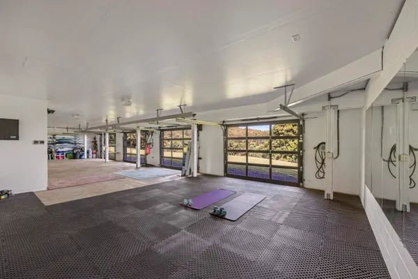 a living room with a large window and furniture