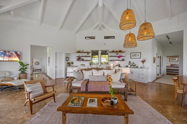 a living room with a table and a chair
