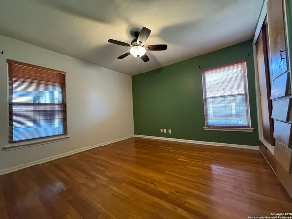 a view of an empty room with chandelier and a window