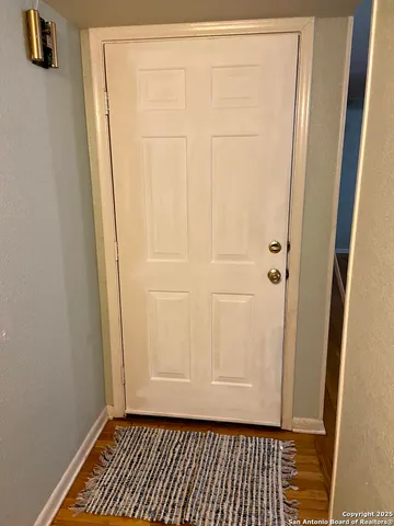 a view of a room with wooden door