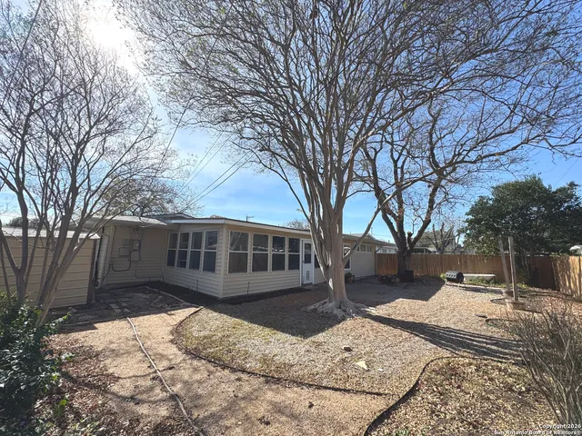 a view of a house with a yard covered in snow