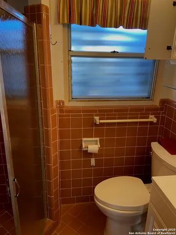 a bathroom with a blue toilet and a sink