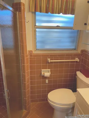 a bathroom with a blue toilet and a sink