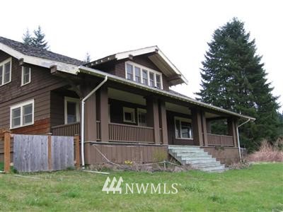 a view of a house with a yard and sitting area