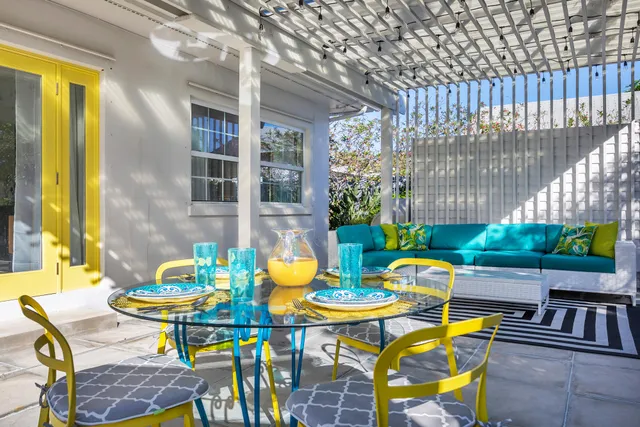 a view of an outdoor dining space with a table and chairs