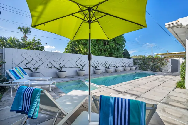a view of an outdoor sitting area with furniture and umbrella