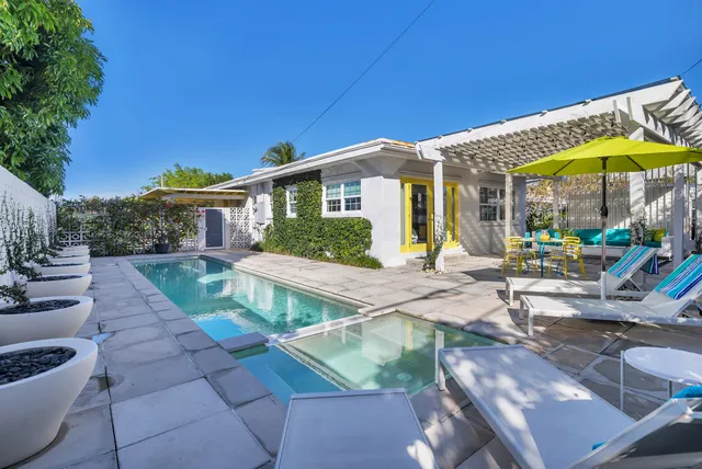 a view of a house with backyard porch and sitting area