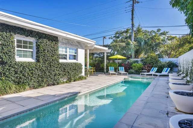 a view of a house with backyard tub and sitting area