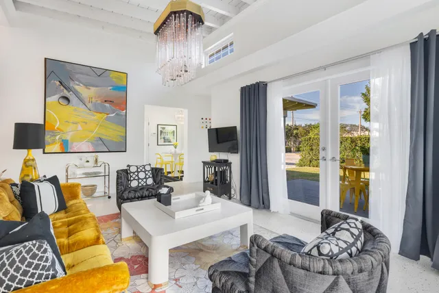 a living room with furniture and a chandelier