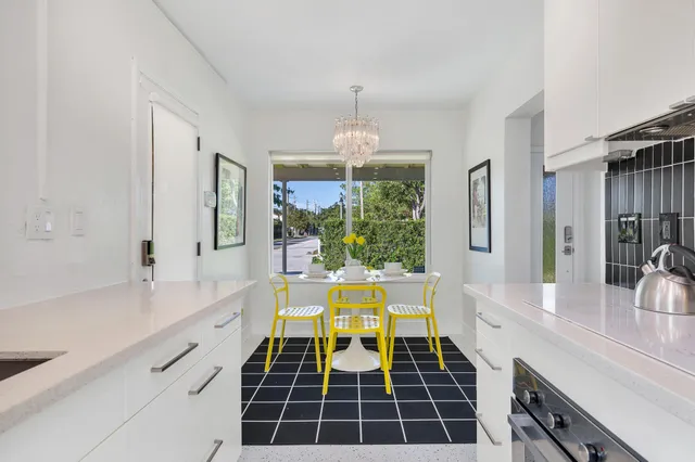 a bathroom with a tub a sink a window and a shower