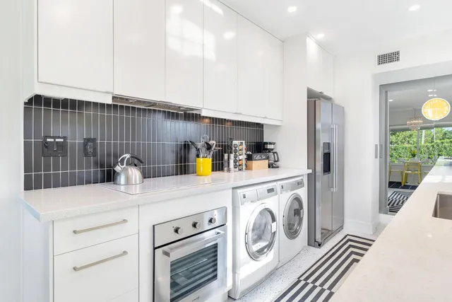 a kitchen with a sink and a washer dryer