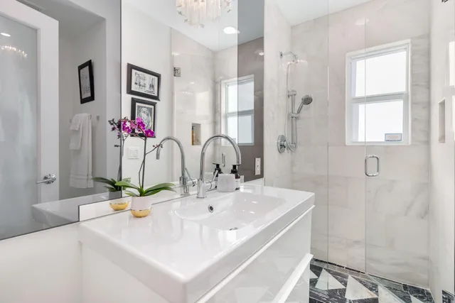 a bathroom with a sink tub and a mirror