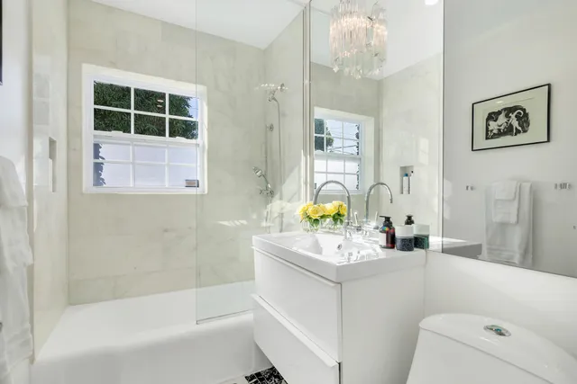 a bathroom with a sink toilet and shower