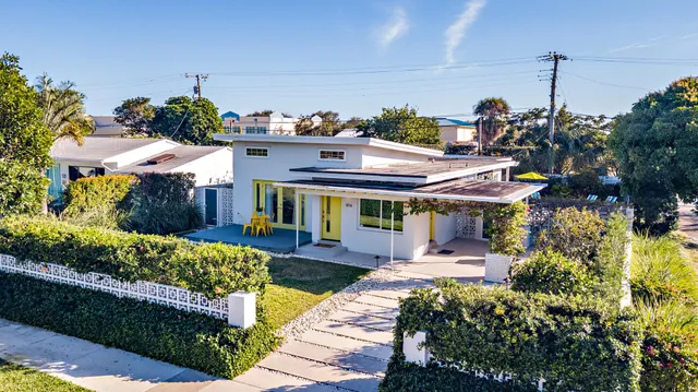 a view of a patio with table and chairs potted plants