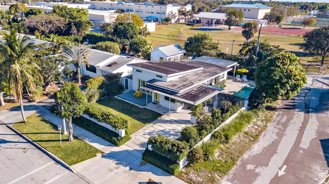 an aerial view of a house with a swimming pool garden and patio