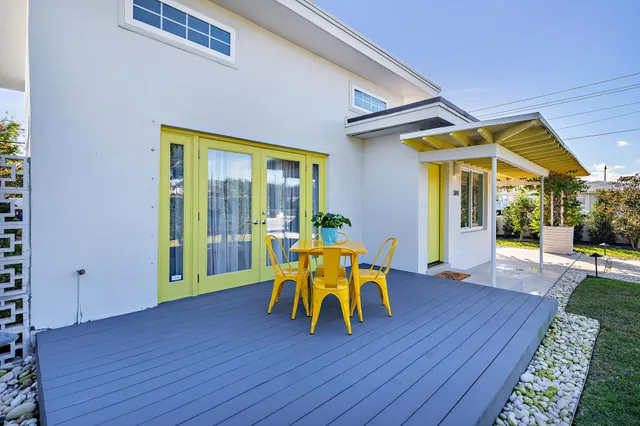 a dining room with wooden floor and white walls