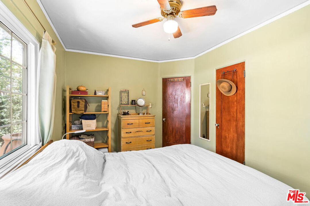 2403 Hyperion Avenue Los Angeles, CA 90027 - Photo 15 of 53 a bedroom with a bed and a chandelier