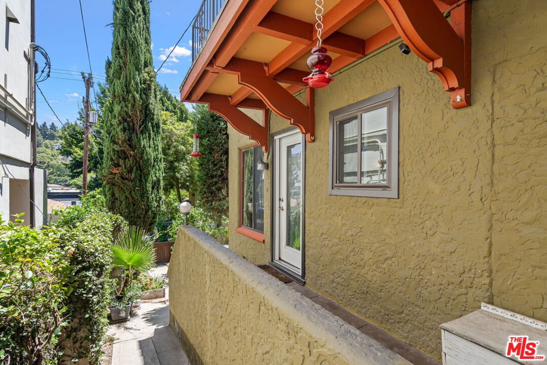 2403 Hyperion Avenue Los Angeles, CA 90027 - Photo 27 of 53 a view of a house with a large windows and flower plants