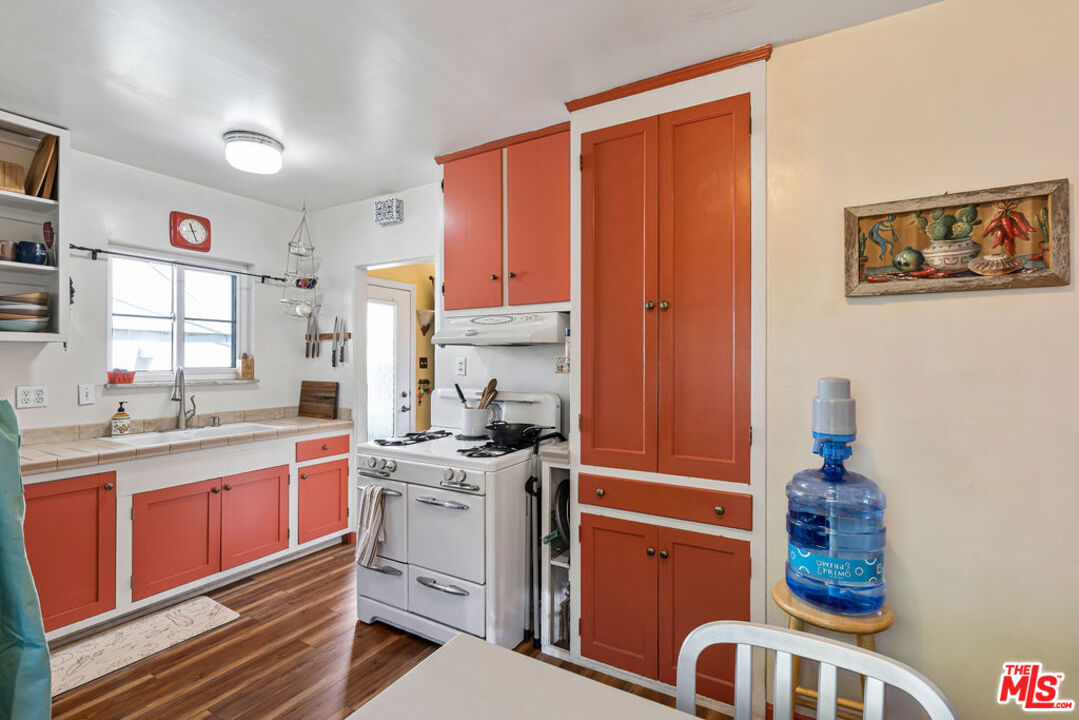 2403 Hyperion Avenue Los Angeles, CA 90027 - Photo 5 of 53 a kitchen that has a lot of cabinets in it and wooden floors