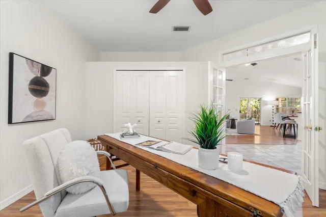 a dining room with furniture and potted plant