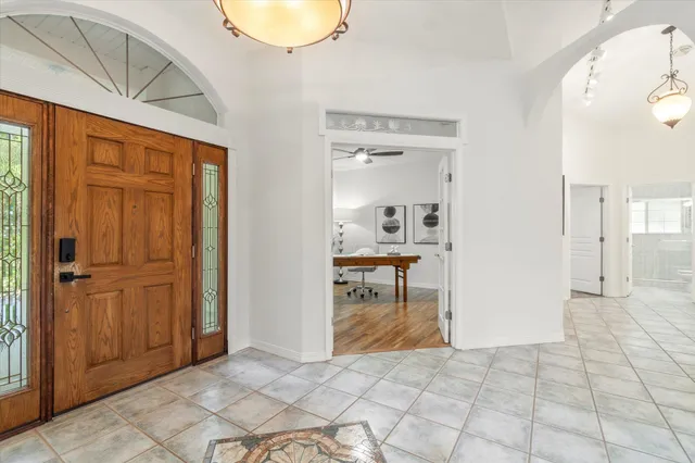 a view of a livingroom with wooden floor and a bathroom