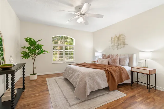 a spacious bedroom with a large bed and a chandelier