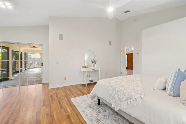a bedroom with a bed and wooden floor