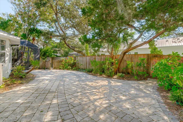 a view of a house with a yard and tree s