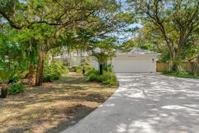a view of backyard of house with outdoor seating and green space