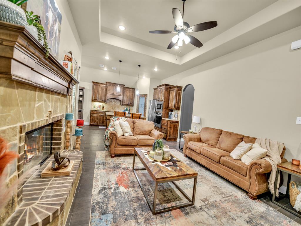 156 Cottongame Road Weatherford, TX 76088 - Photo 7 of 35 a living room with furniture ceiling fan and a rug