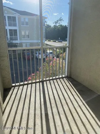 a view of balcony with wooden floor and fence