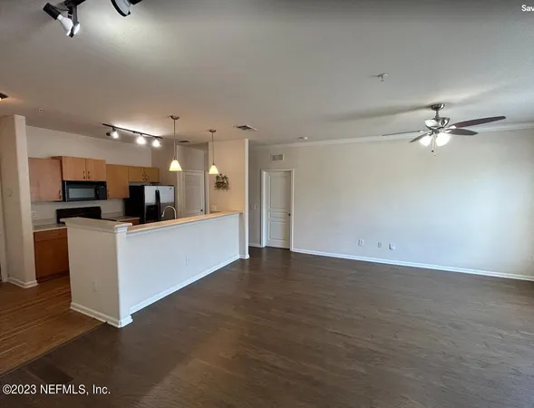 a view of a kitchen with furniture and a ceiling fan
