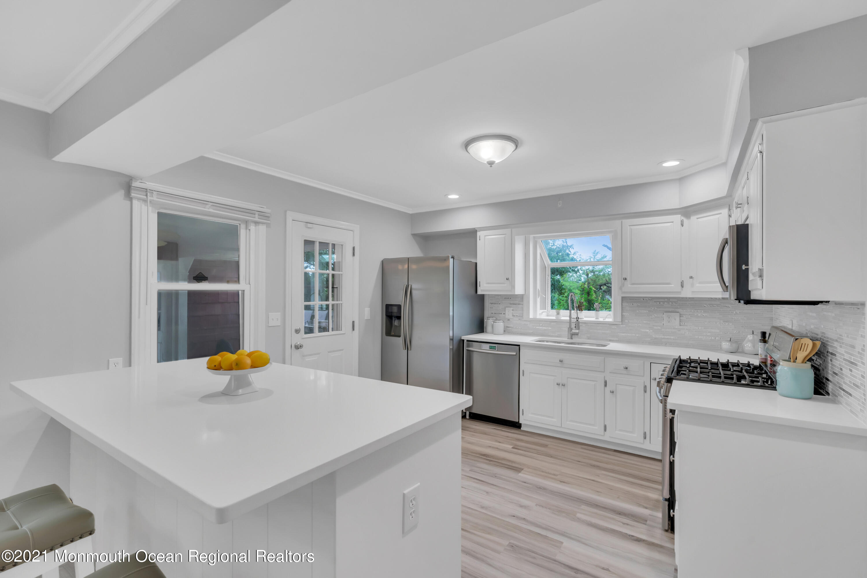 1675 Forge Pond Road Brick, NJ 08724 - Photo 15 of 69 a kitchen with a sink a stove and chairs