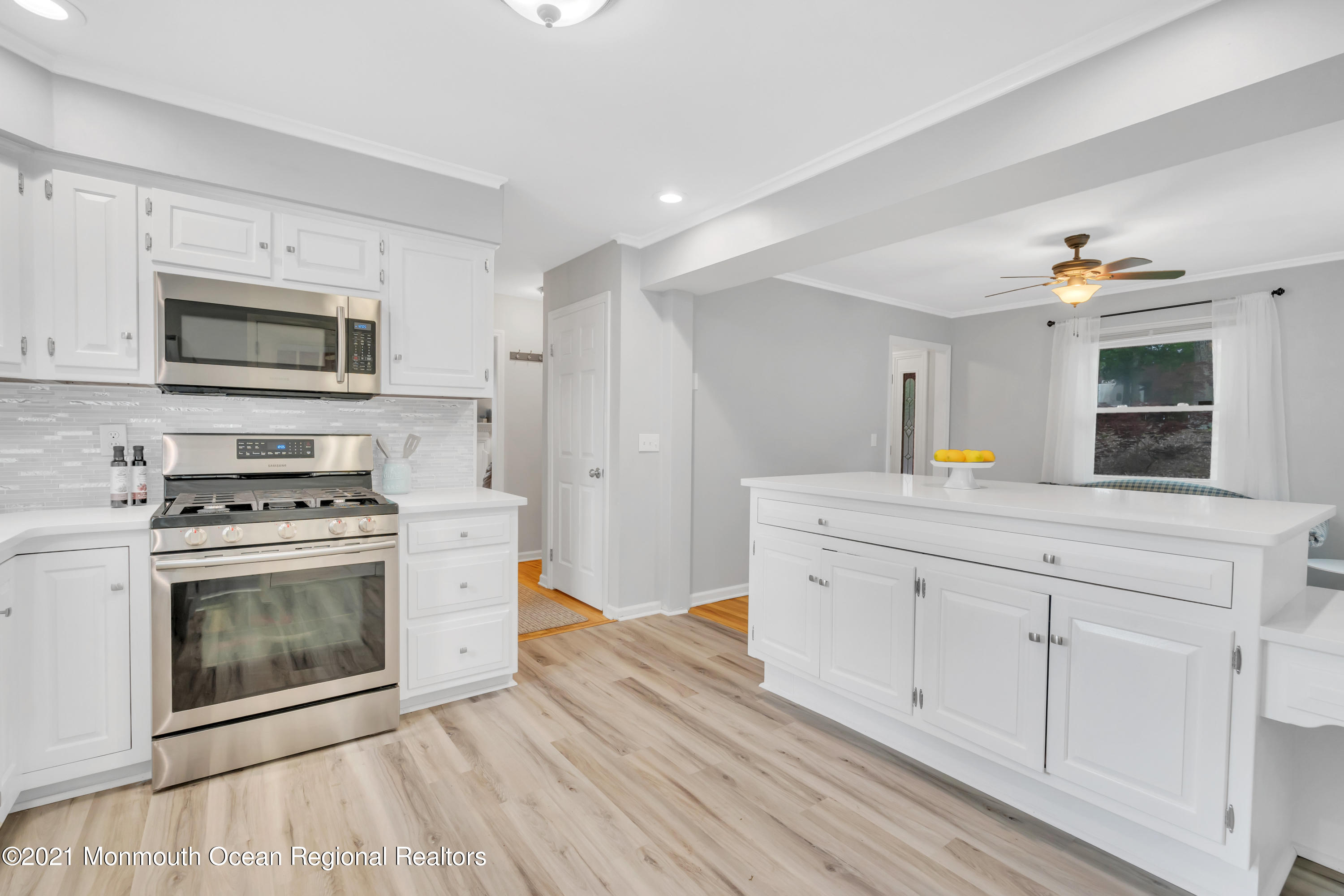 1675 Forge Pond Road Brick, NJ 08724 - Photo 18 of 69 a kitchen with stainless steel appliances white cabinets a stove a sink and a microwave