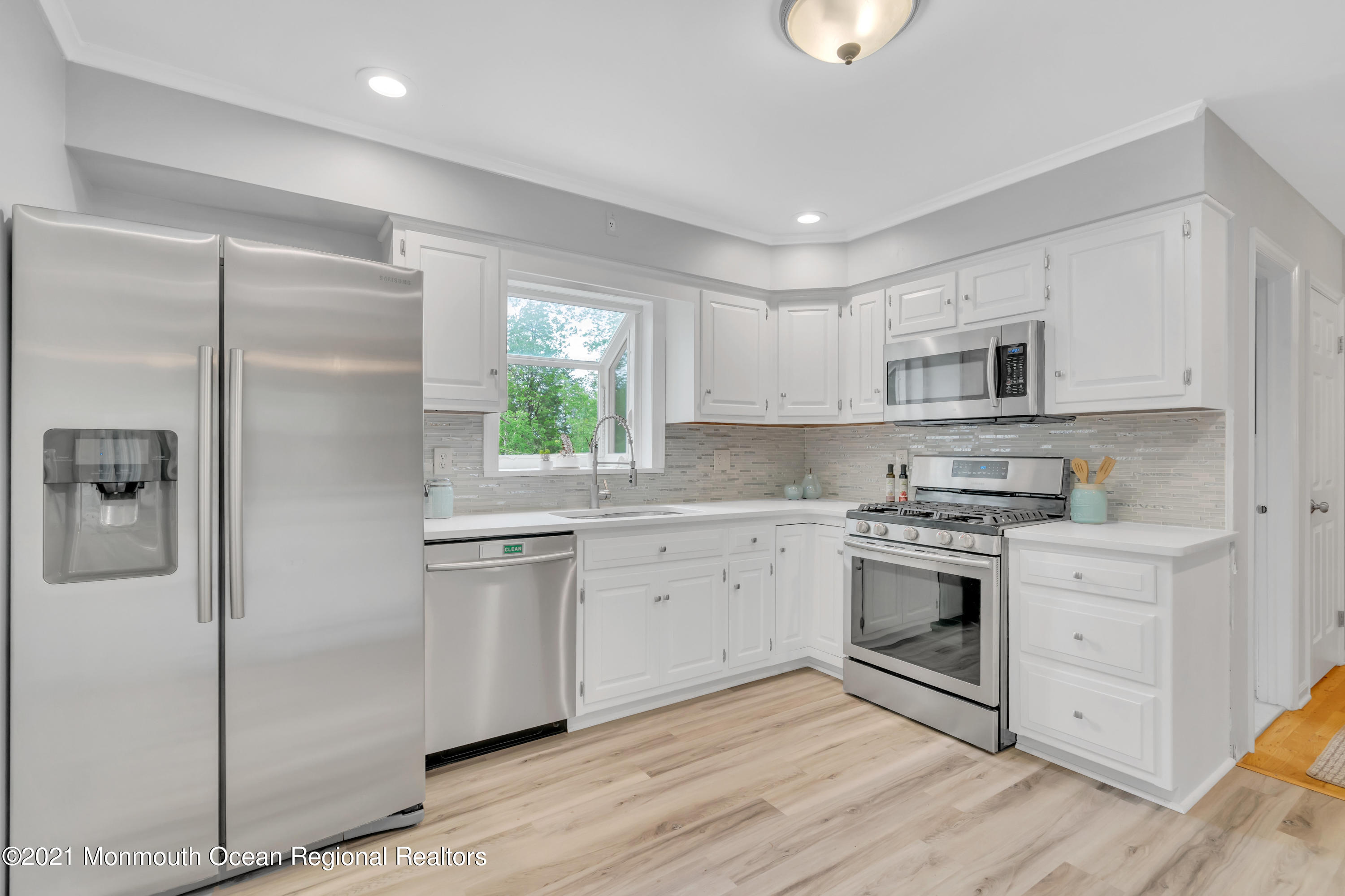 1675 Forge Pond Road Brick, NJ 08724 - Photo 19 of 69 a kitchen with a sink cabinets stainless steel appliances and a window