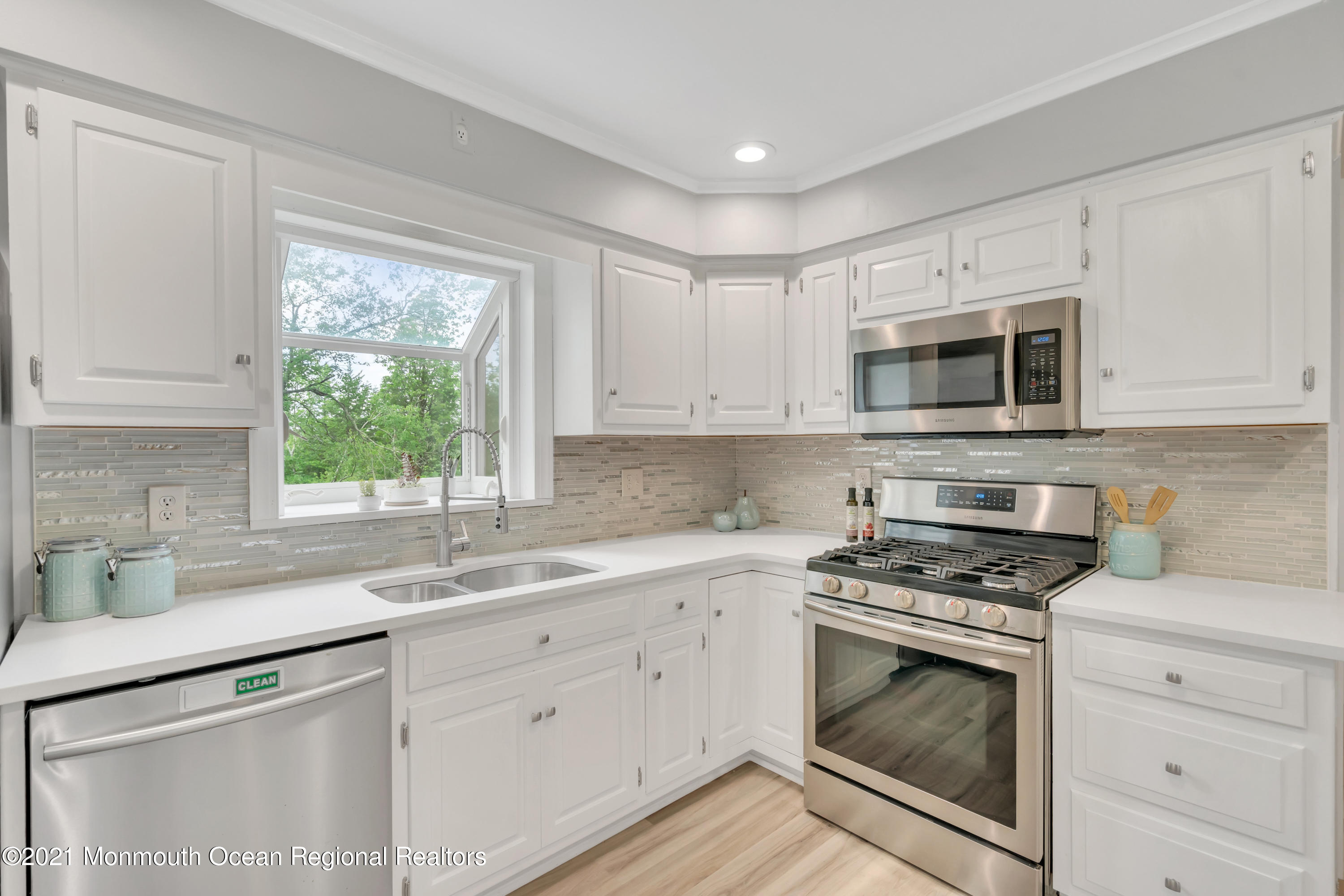 1675 Forge Pond Road Brick, NJ 08724 - Photo 20 of 69 a kitchen with white cabinets appliances a sink and a window