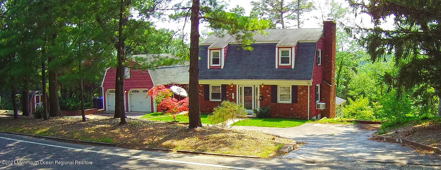 1675 Forge Pond Road Brick, NJ 08724 - Photo 63 of 69 a view of a brick house with large windows and plants
