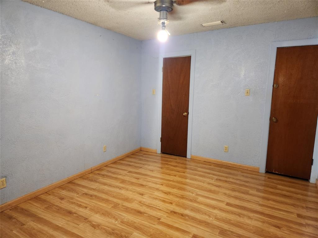 209 East 2nd Street Quinlan, TX 75474 - Photo 7 of 13 a view of empty room with wooden floor