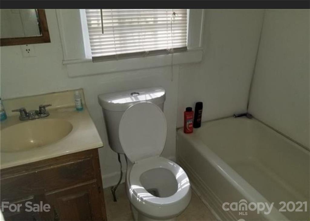 5226 Tuckaseegee Road Charlotte, NC 28208 - Photo 13 of 18 a bathroom with a toilet and a sink