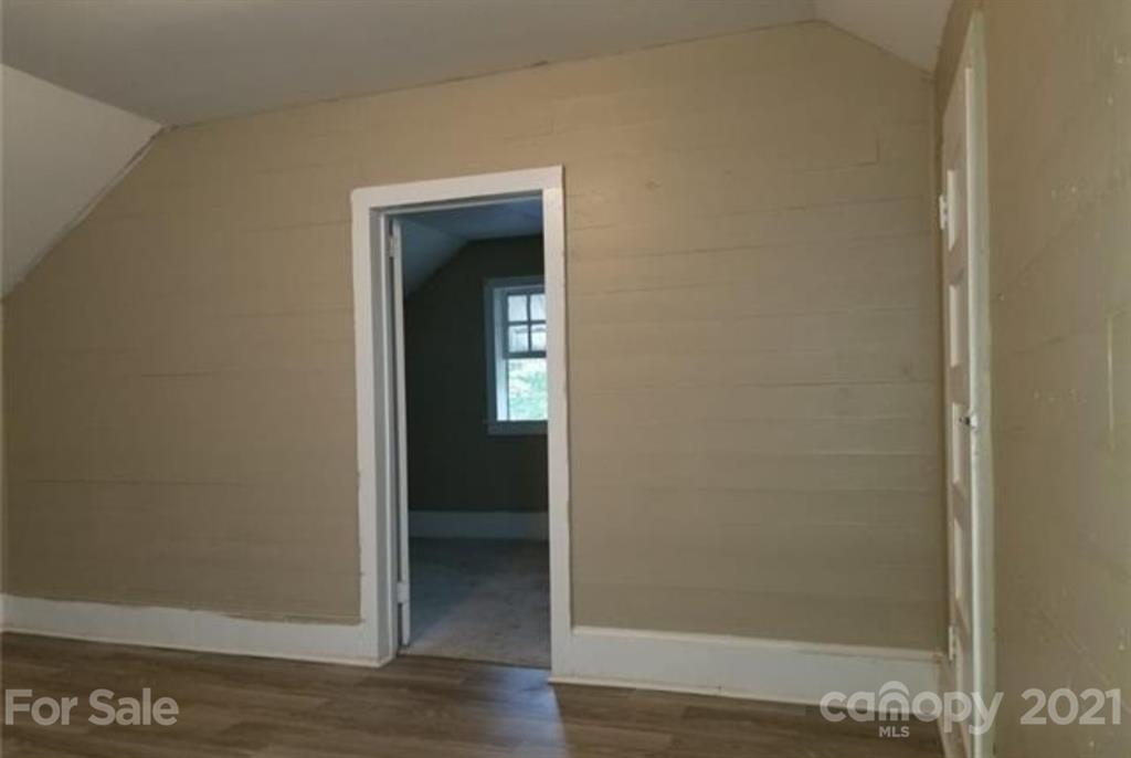 5226 Tuckaseegee Road Charlotte, NC 28208 - Photo 17 of 18 a view of a hallway with wooden floor