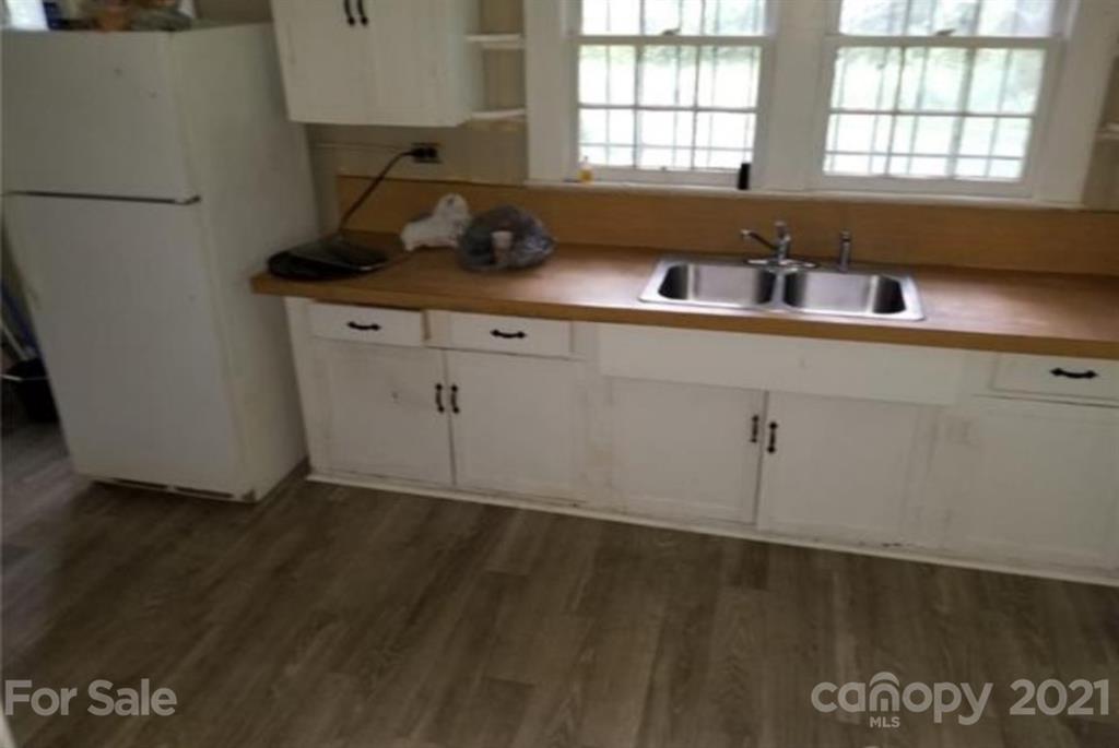 5226 Tuckaseegee Road Charlotte, NC 28208 - Photo 3 of 18 a kitchen with a sink cabinets and window