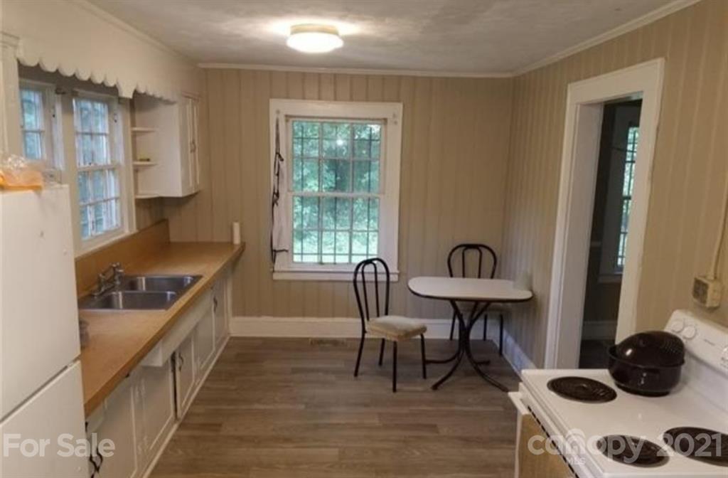 5226 Tuckaseegee Road Charlotte, NC 28208 - Photo 4 of 18 a kitchen with stainless steel appliances granite countertop a stove a sink and a refrigerator