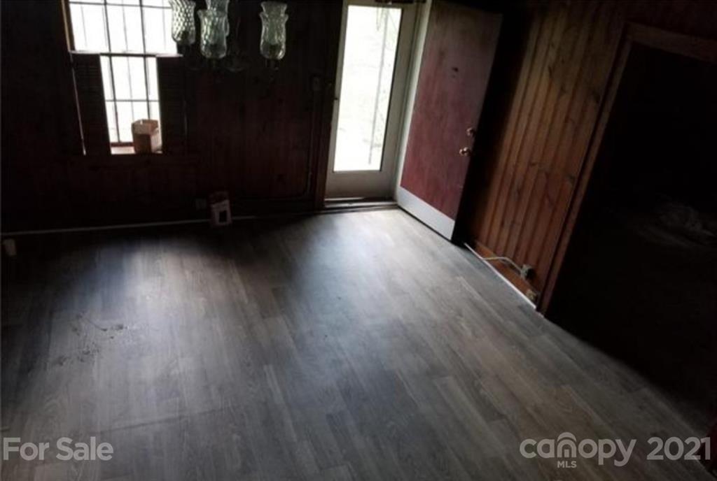 5226 Tuckaseegee Road Charlotte, NC 28208 - Photo 7 of 18 a view of a room with wooden floor and windows