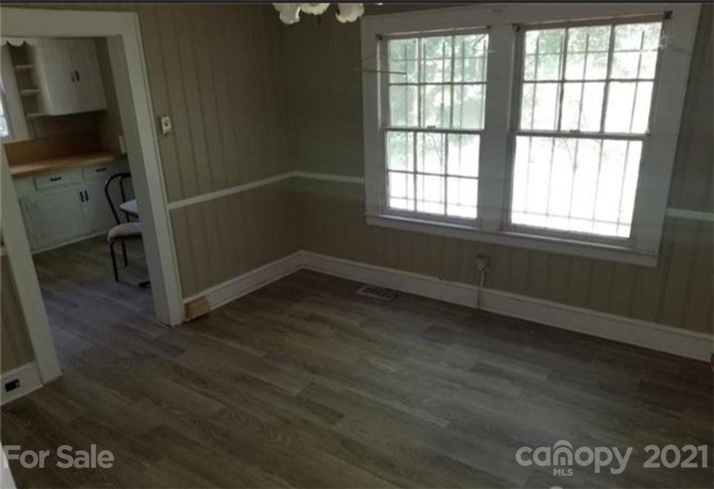 5226 Tuckaseegee Road Charlotte, NC 28208 - Photo 10 of 18 an empty room with wooden floor and windows
