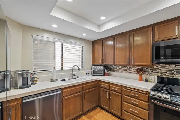 a kitchen with stainless steel appliances a sink stove and cabinets
