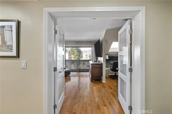 a living room with furniture floor to ceiling window and wooden floor