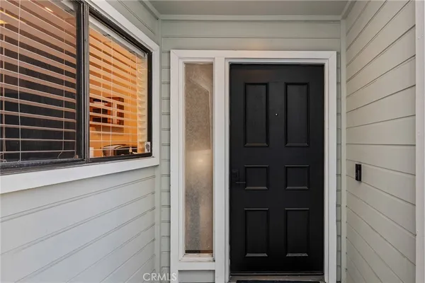 a view of an entryway with wooden floor