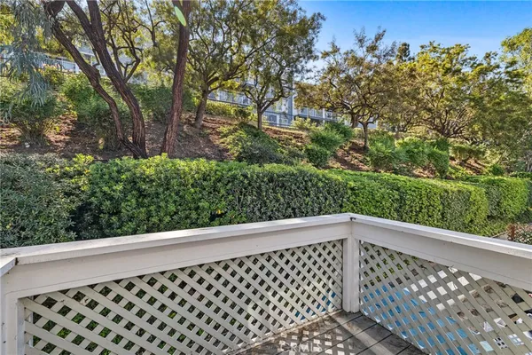a view of backyard with swimming pool and trees