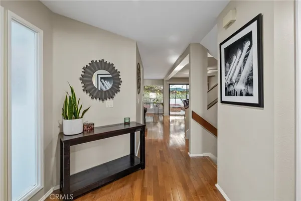 a view of a dining room with furniture wooden floor and chandelier