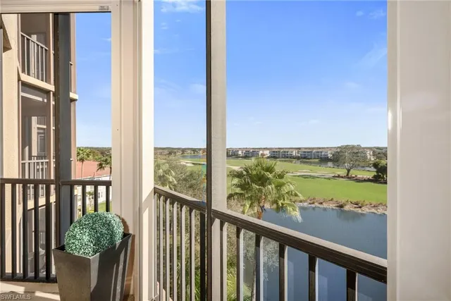 a view of a balcony with lake view and wooden floor